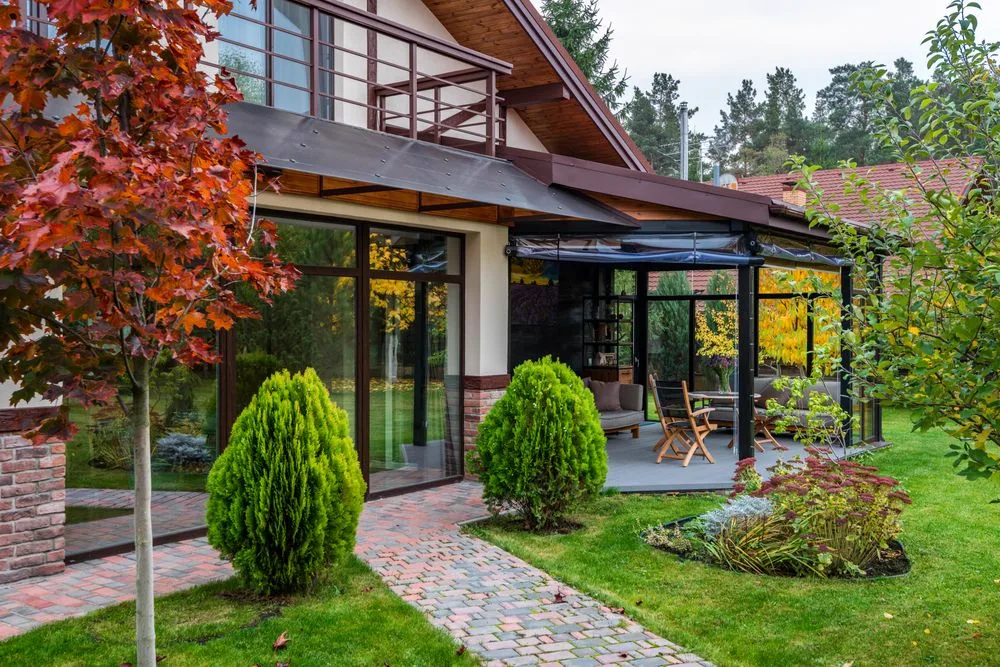 House exterior with a paved garden path leading to a garden room