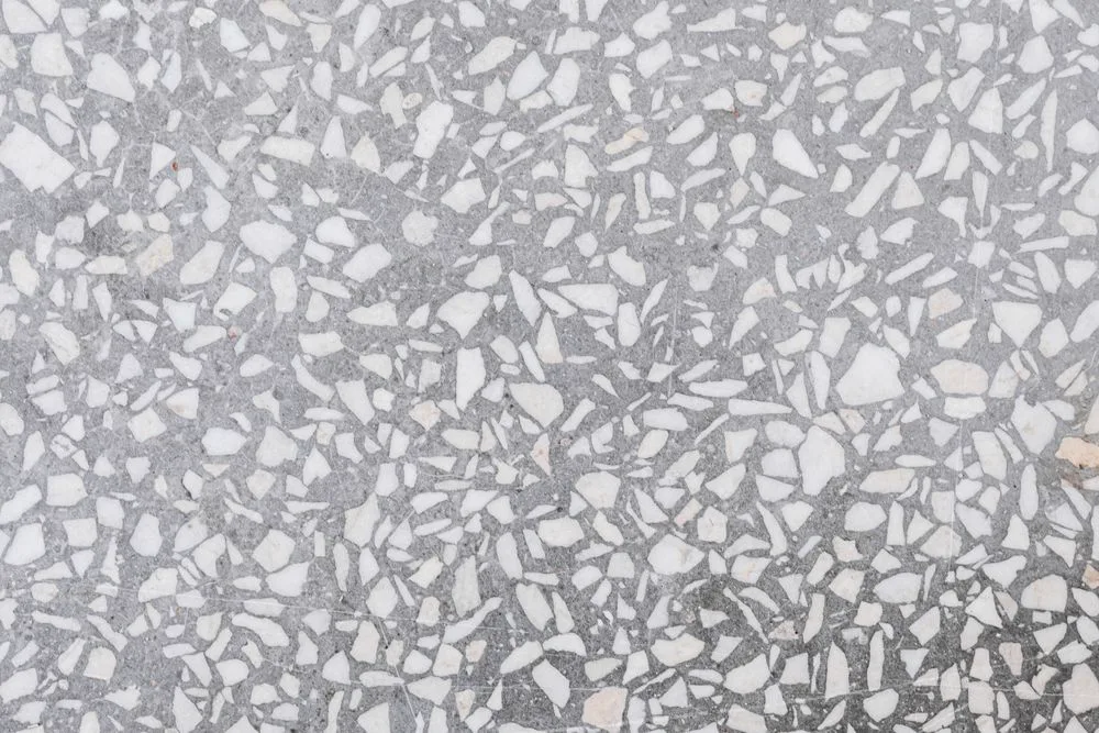 Smooth polished stone aggregate surface in grey and white tones